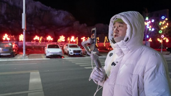 在吉林市阿什哈達(dá)霧凇觀景帶，霧凇播報(bào)員正在直播。新華社記者 李典 攝